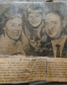 Connie Rich (center) holds a gold engraved watch beside her father Theodore “Bud” Nelson (right) and mother Ginnie Nelson, earned by her father as Outstanding Pilot of the Year in the Helicopter Association of America, as printed in the Los Angeles Times.