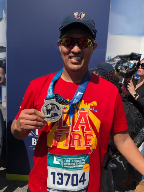 LA Marathon Team member Miguel Rodriquez with medal