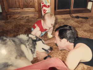 A young Jason with his father and trained Malamute