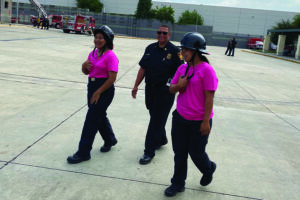 Camp attendees walking with firefighter.