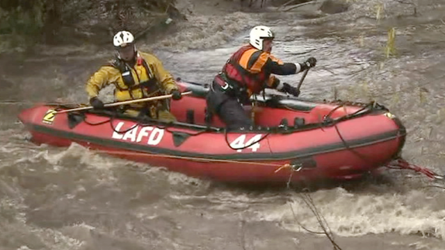 LAFD Swiftwater team on boat in fast moving flood waters